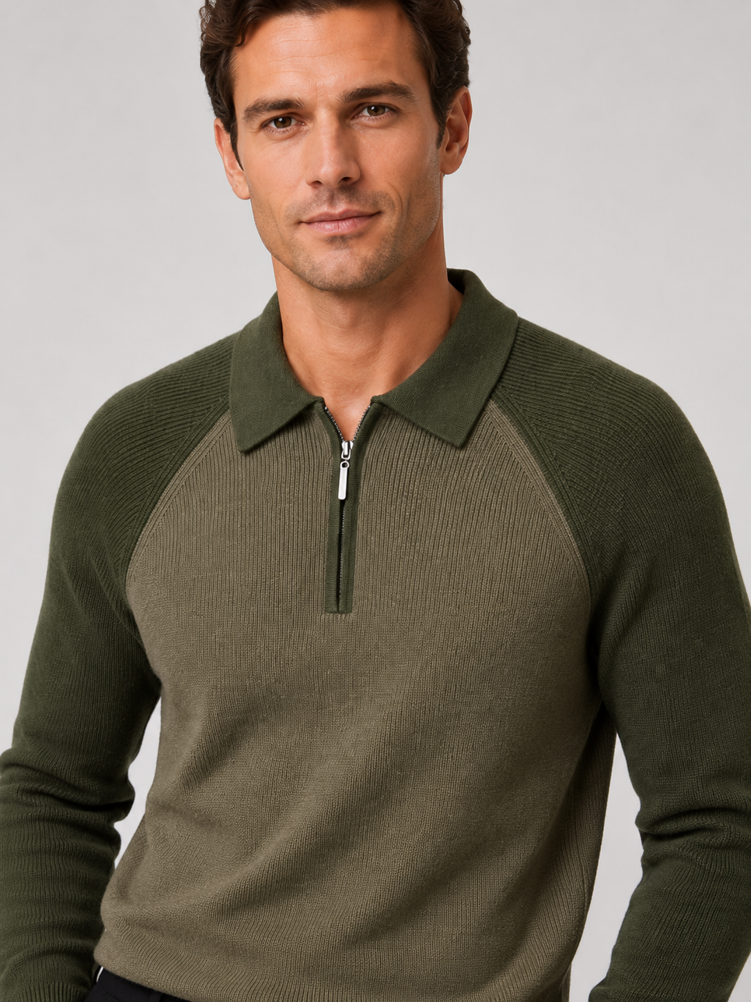 Close-up of a green quarter zip polo sweater showing the knit texture, zipper, collar, cuffs, and stitching
