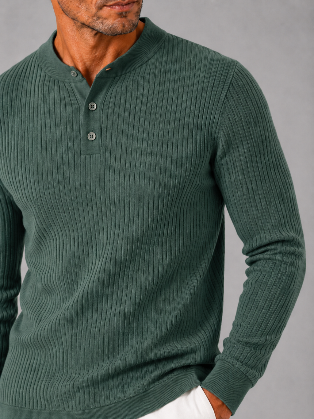 Close up of green ribbed henley polo showing striped knit texture and button detail