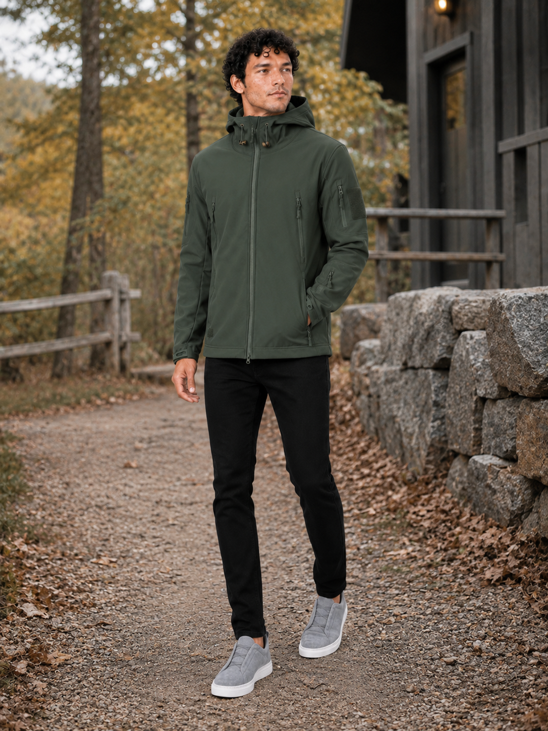 Man styling green tactical hooded jacket in a rugged outdoor work and hiking lifestyle outfit