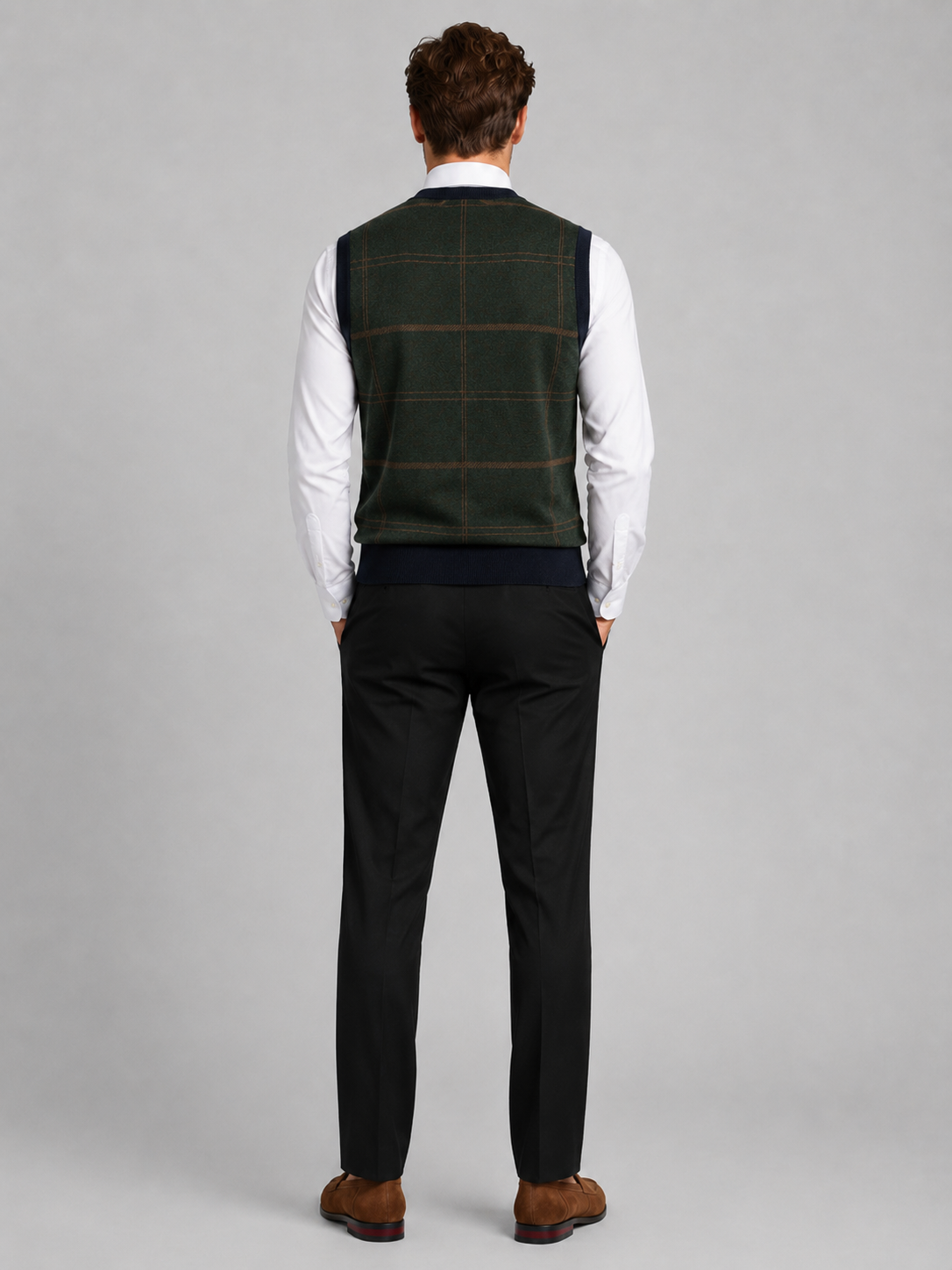 Back view of a man wearing a green V-neck sweater vest showing the sleeveless cut, warm knit fabric, and comfortable fit