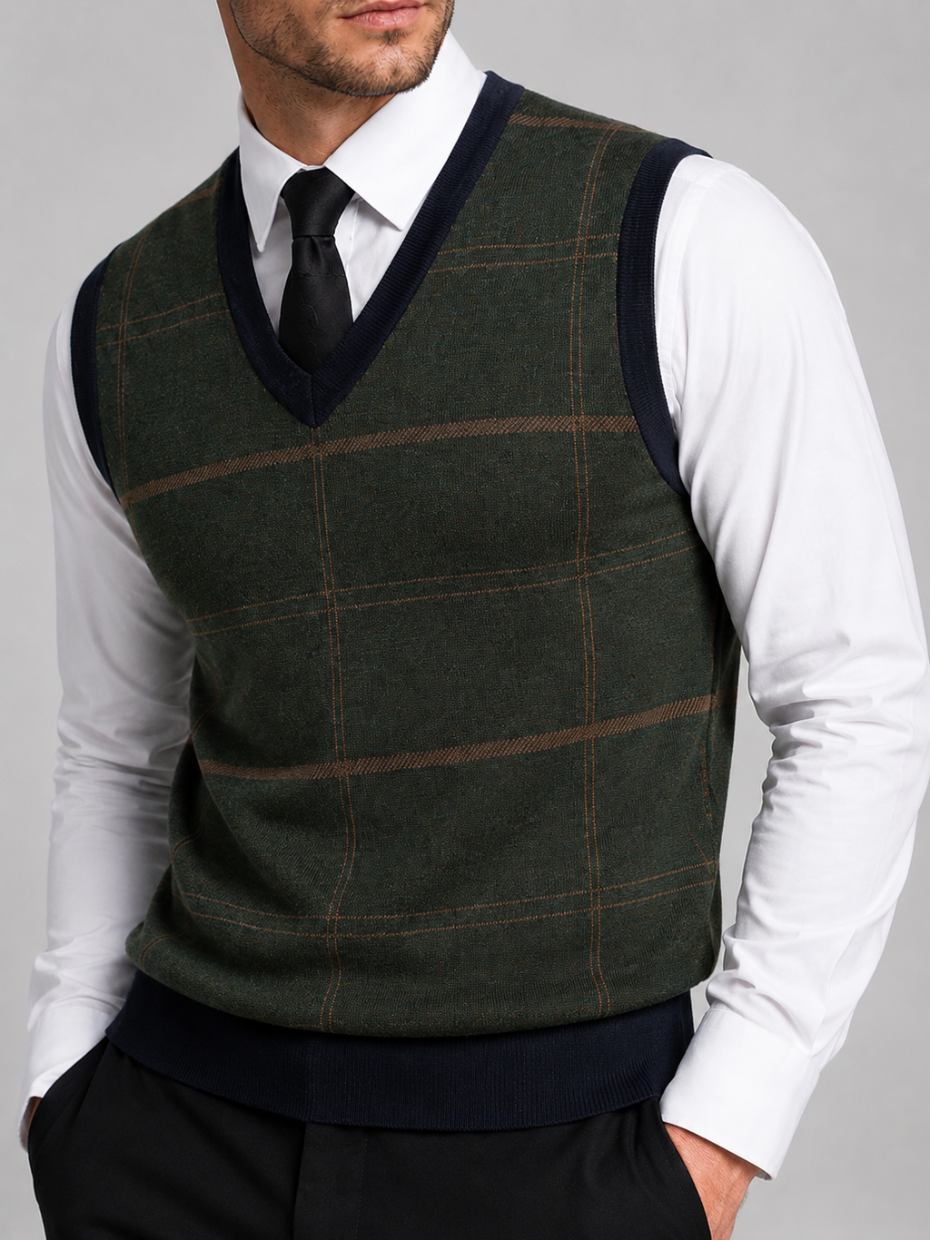 Close-up of a green V-neck sweater vest showing the diamond pattern, cable knit texture, ribbed neckline, armholes, and hem