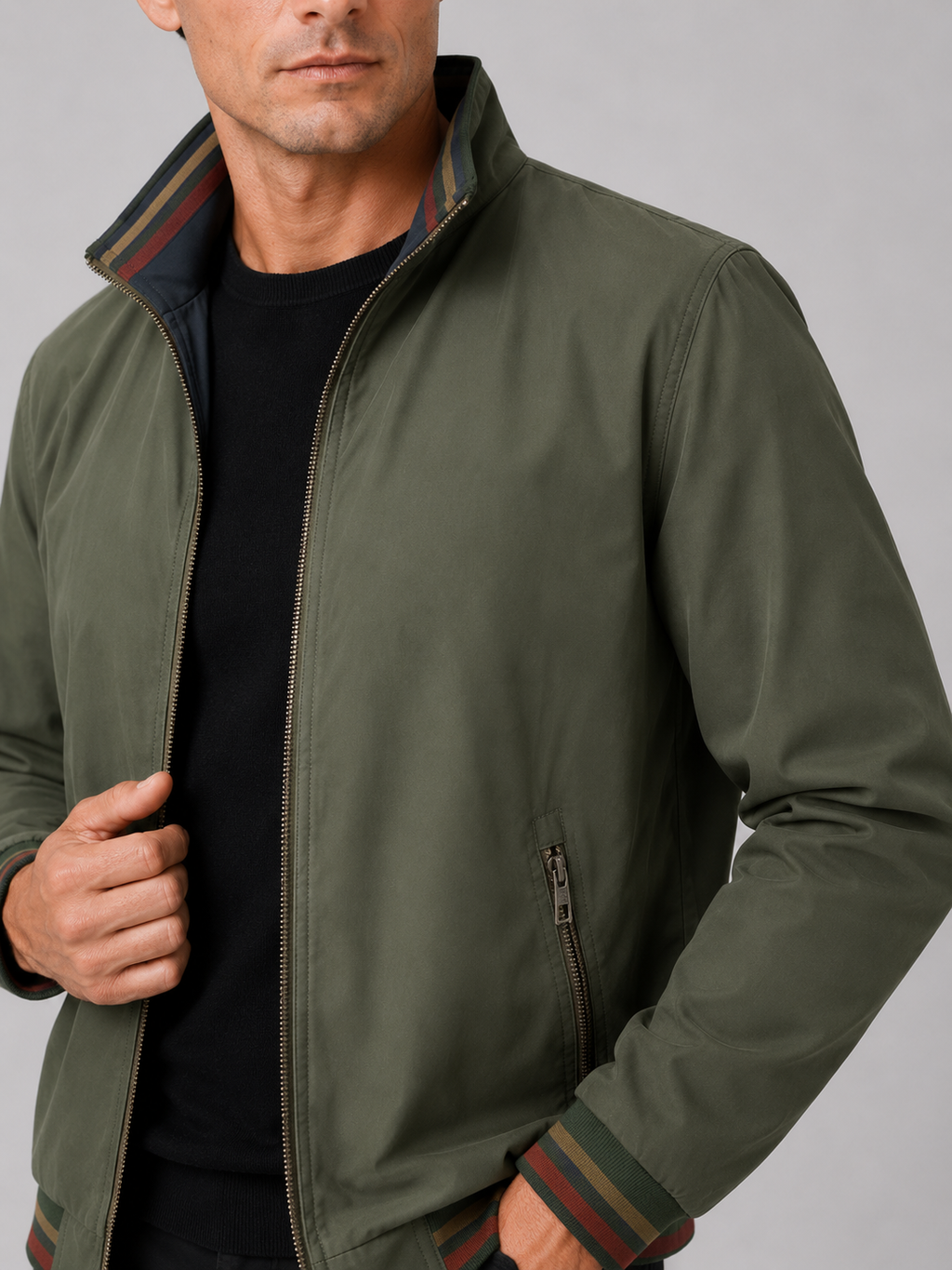 Close up of green varsity jacket showing snap button closure and reversible design detail