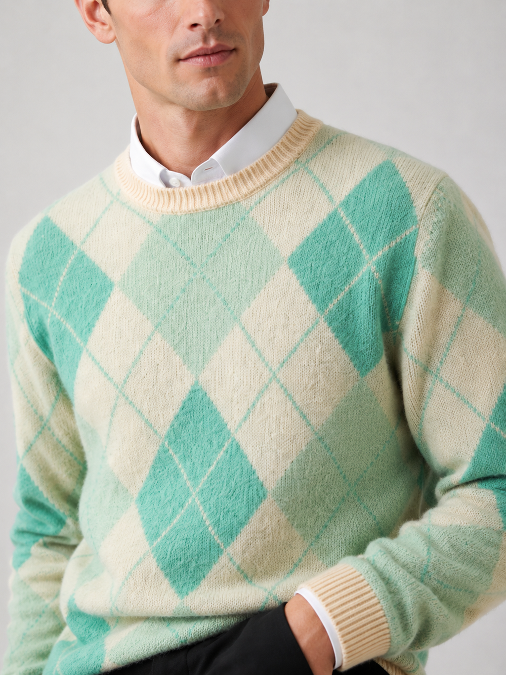 Back view of a man wearing a green wool argyle sweater showing the crew neck, long sleeves, thick knit fabric, and comfortable fit