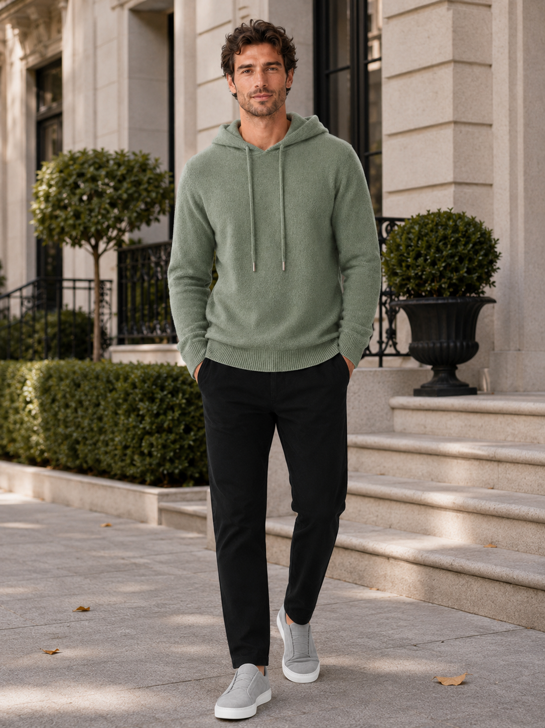 Man wearing a green wool hoodie sweater in a casual fall winter outfit for everyday wear