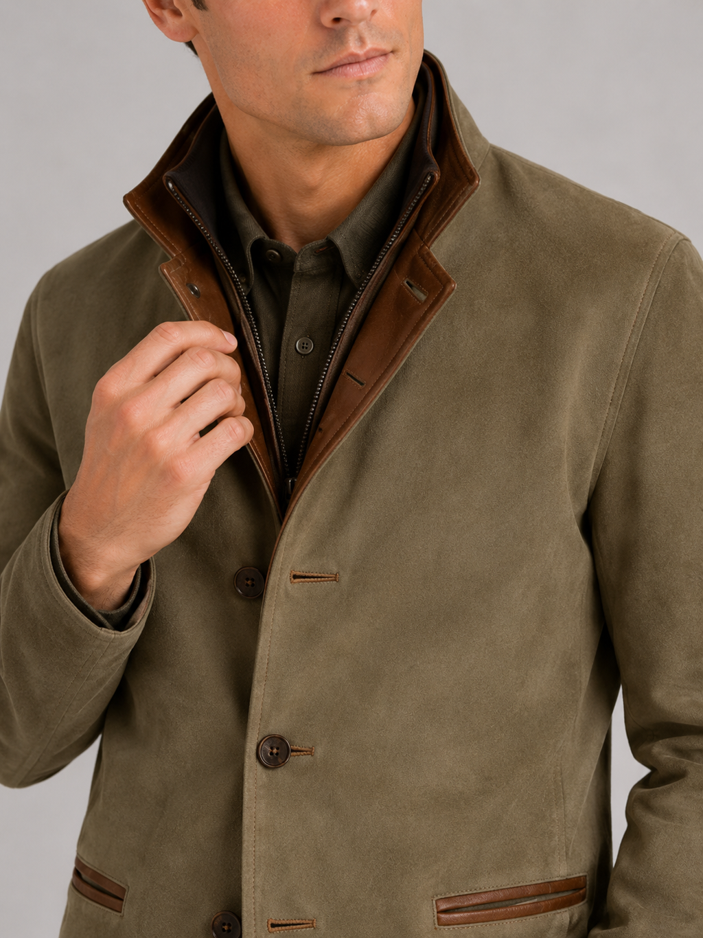 Close up of green workwear jacket showing contrast color details and durable fabric texture