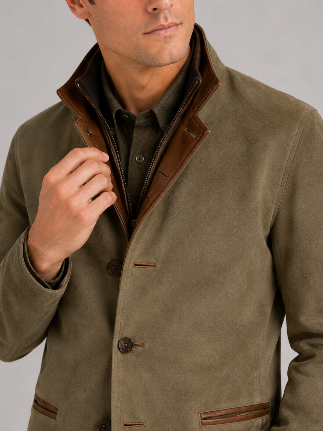 Close up of green workwear jacket showing contrast color details and durable fabric texture