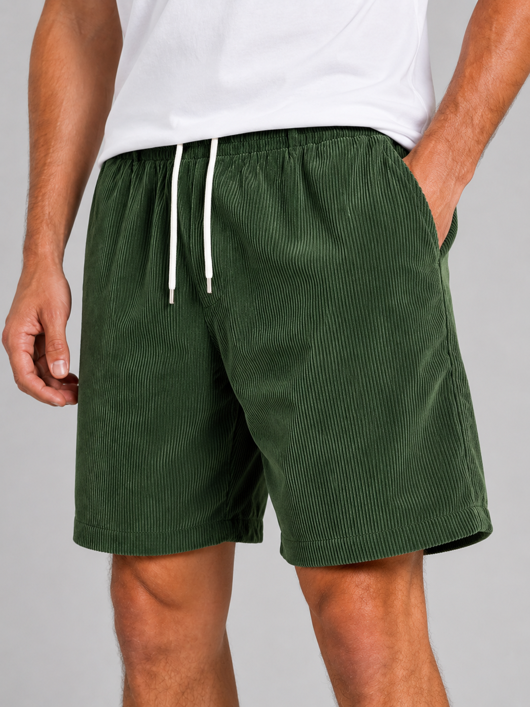 Close up of green corduroy shorts showing soft textured fabric and adjustable drawstring waistband