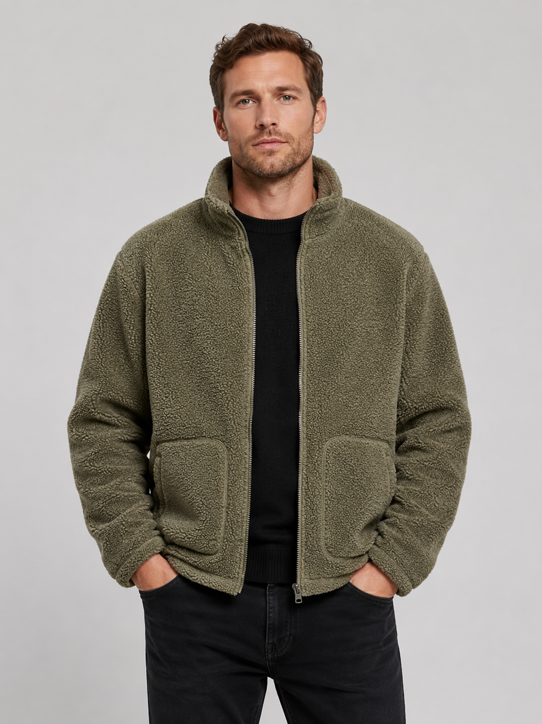 Front view of a man wearing a green full zip fleece jacket with a stand collar, loose fit, long sleeves, and warm fall winter design