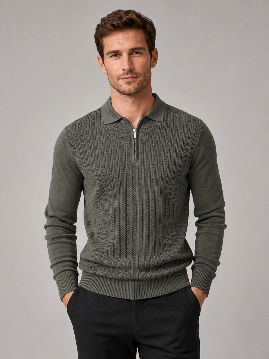 Front view of a man wearing a green quarter zip polo shirt with a slim fit, textured fabric, long sleeves, and structured collar