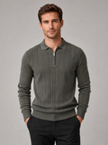 Front view of a man wearing a green quarter zip polo shirt with a slim fit, textured fabric, long sleeves, and structured collar