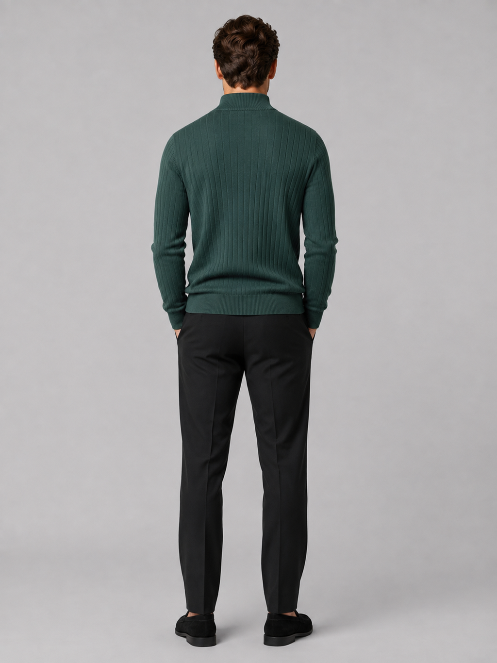 Back view of a man wearing a green quarter zip sweater showing the long sleeves, clean knit construction, and comfortable fit