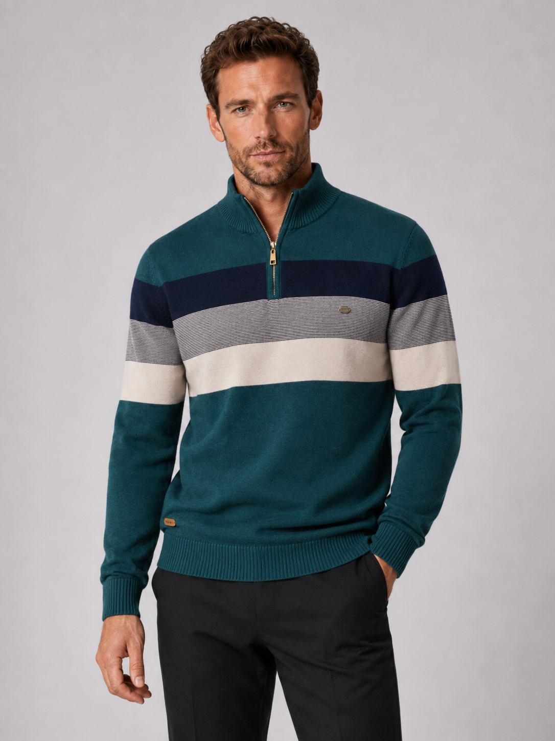 Front view of a man wearing a green patchwork cotton quarter zip sweater with a mock neck and long sleeves