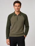 Front view of a man wearing a green slim fit quarter zip polo sweater with long sleeves and a knit collar