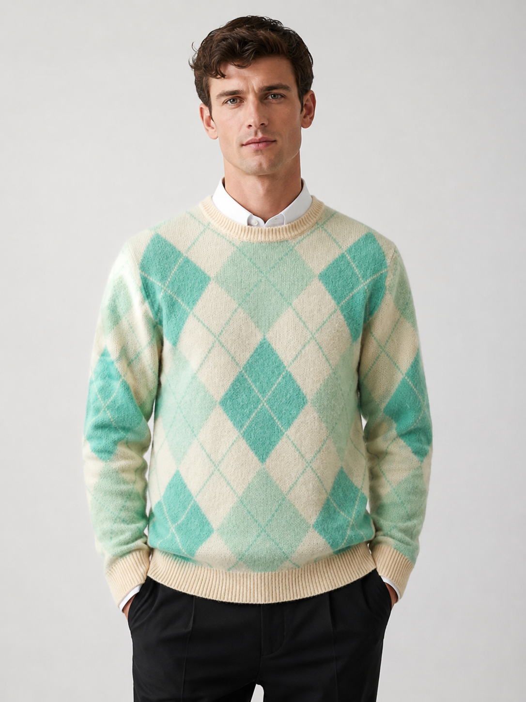 Front view of a man wearing a green wool argyle sweater with a crew neck, long sleeves, and thick warm knit construction
