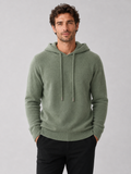 Front view of a man wearing a green wool hoodie sweater with a soft knit design, attached hood, and long sleeves