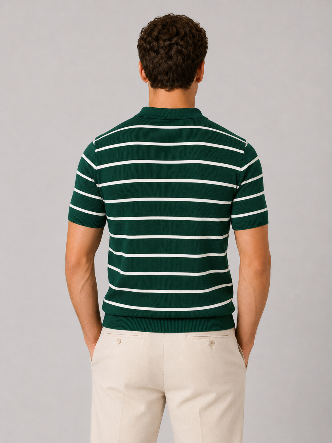Close up of green striped knit polo fabric showing soft breathable texture and quarter zip detail