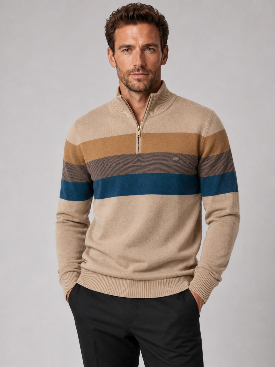 Front view of a man wearing a khaki patchwork cotton quarter zip sweater with a mock neck and long sleeves