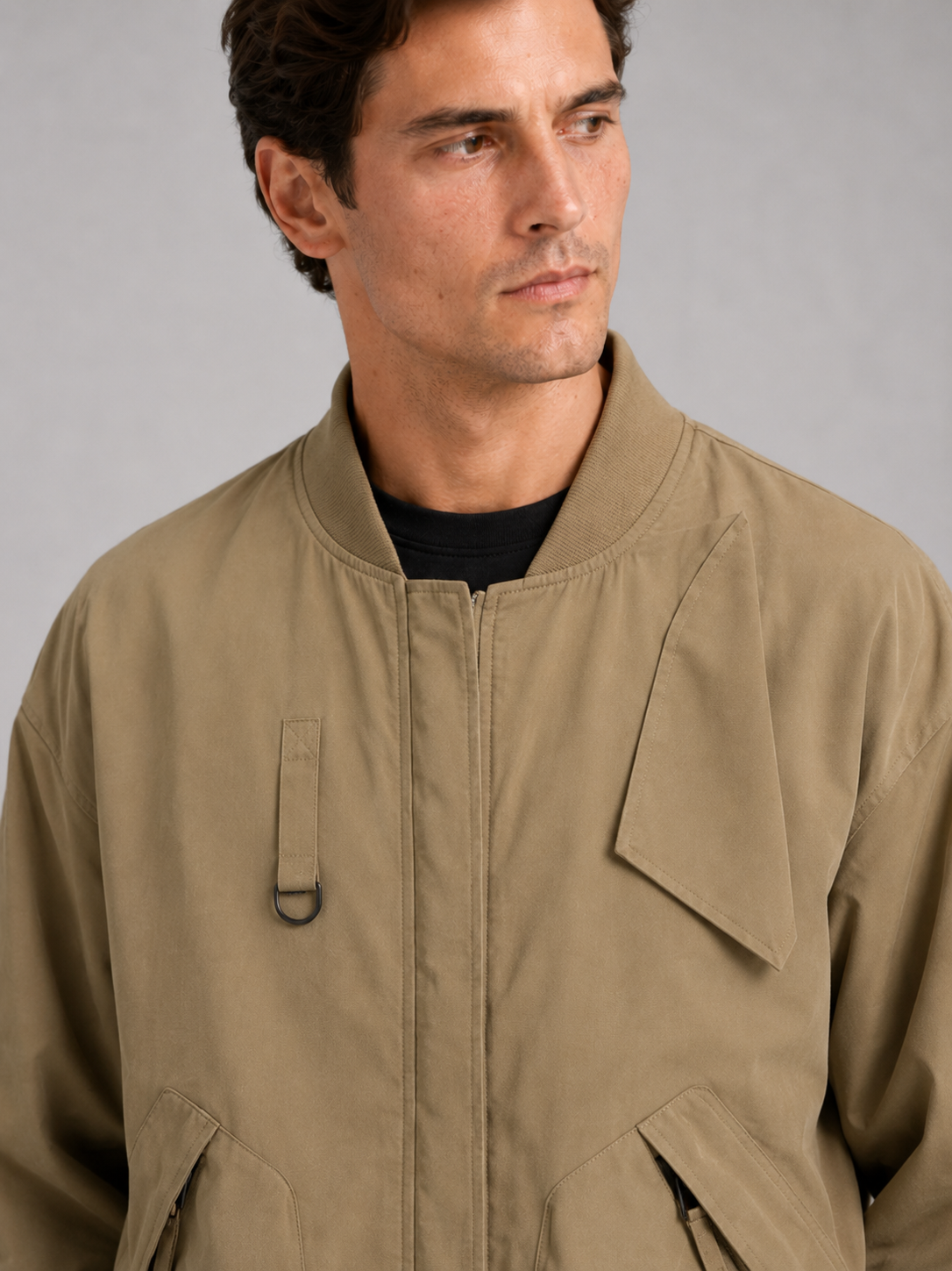 Close up of khaki bomber jacket showing durable fabric and ribbed collar detail