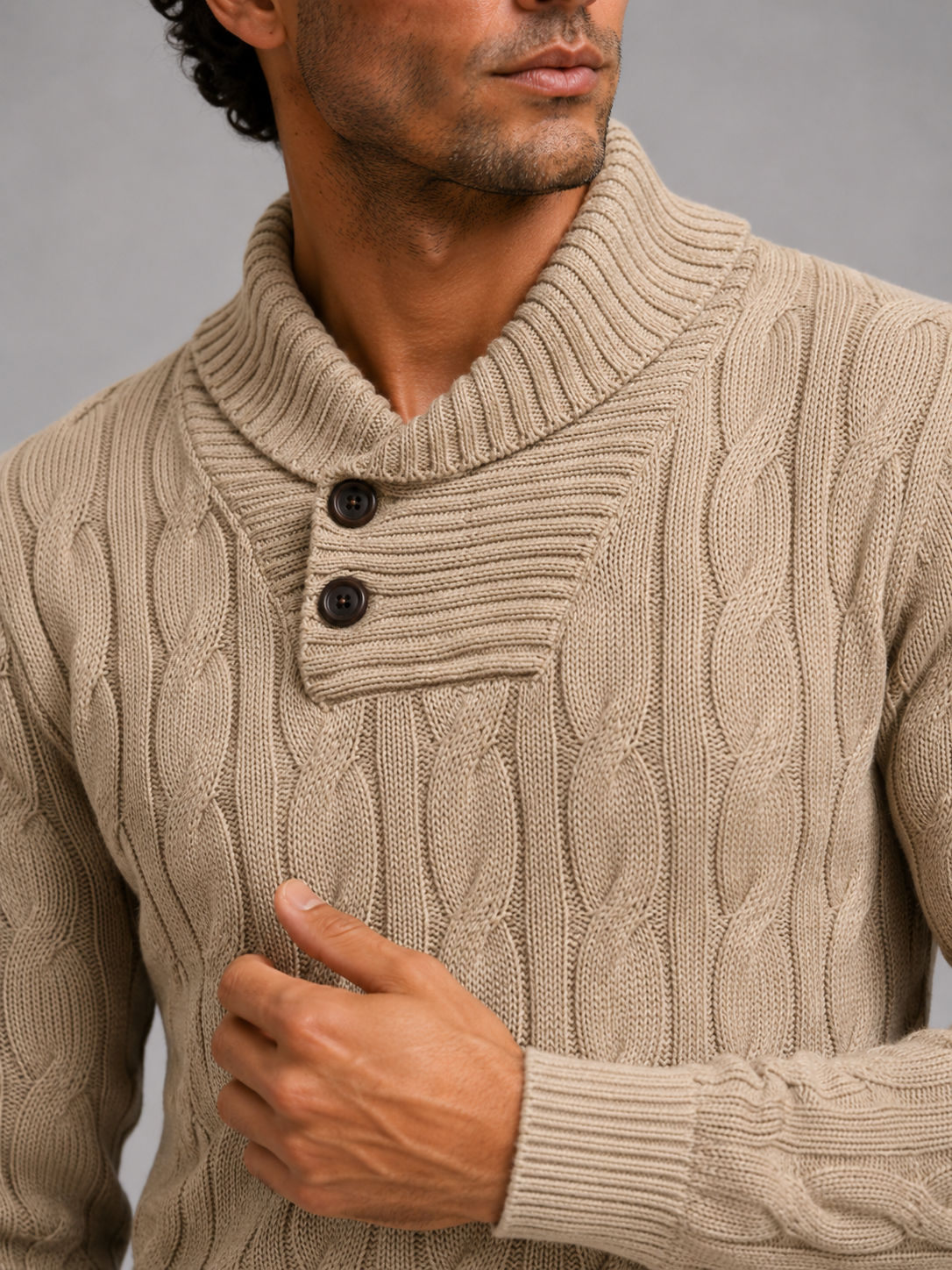 Close up of khaki cable knit sweater showing thick textured fabric and refined v neck detail