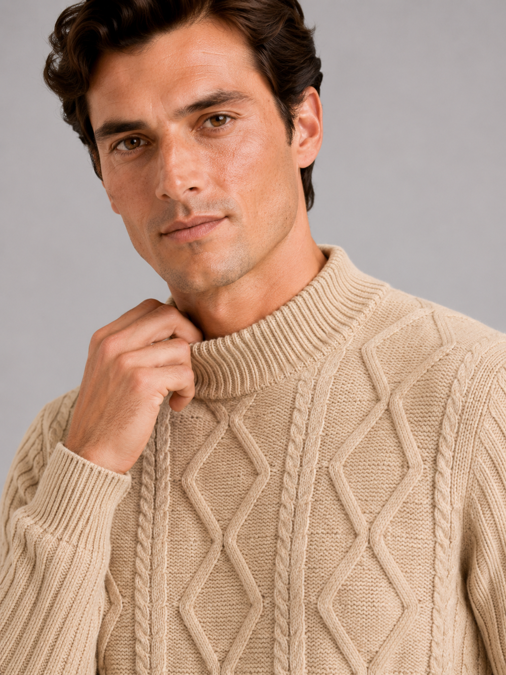 Close up of khaki mock neck sweater showing jacquard twist cable knit texture and soft warm fabric