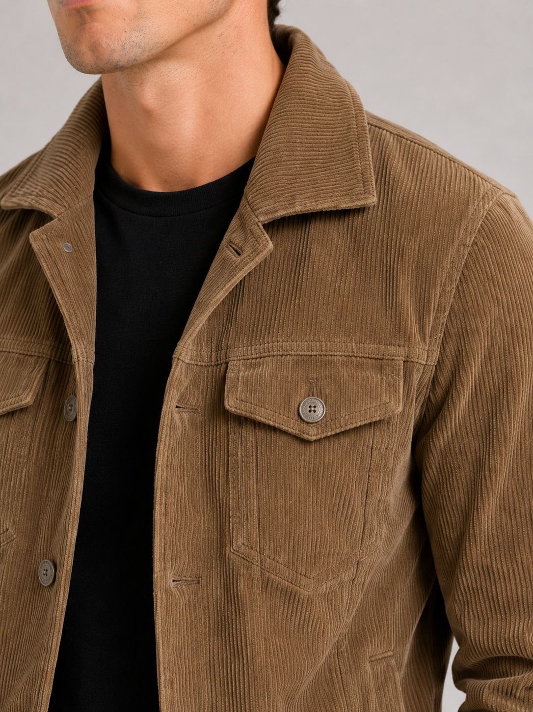 Close up of khaki corduroy jacket showing soft ribbed texture and refined fabric detail
