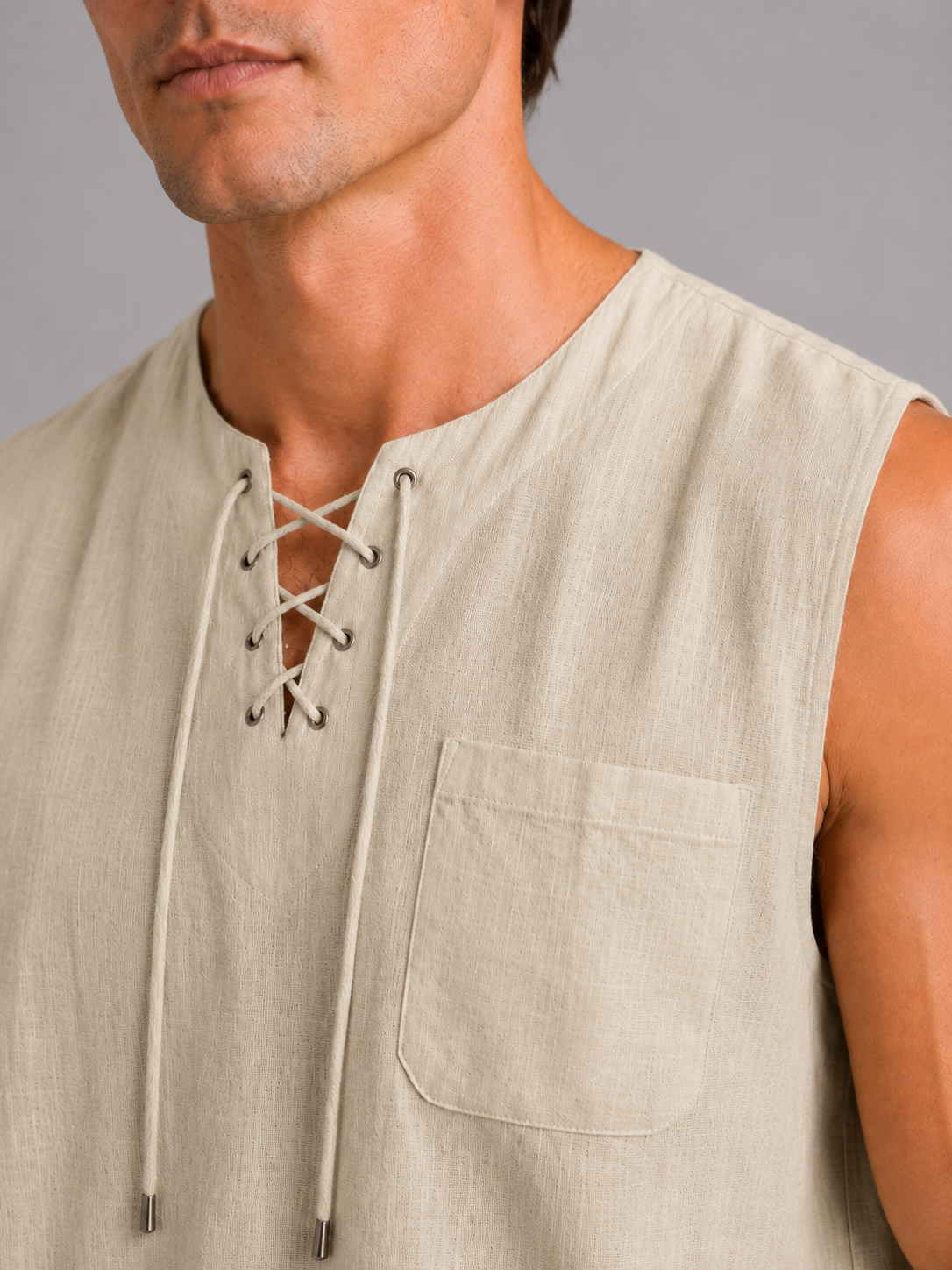 Close up of khaki cotton linen tank top showing breathable fabric texture and lace up neckline detail