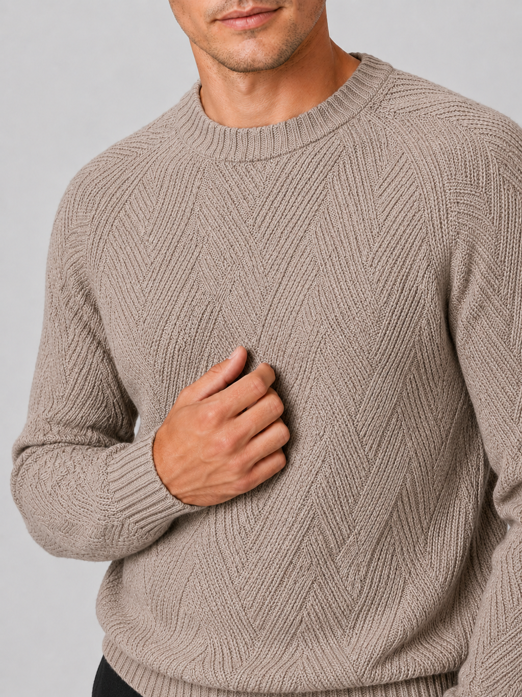 Close up of khaki knit sweater showing soft textured fabric and classic crew neck detail