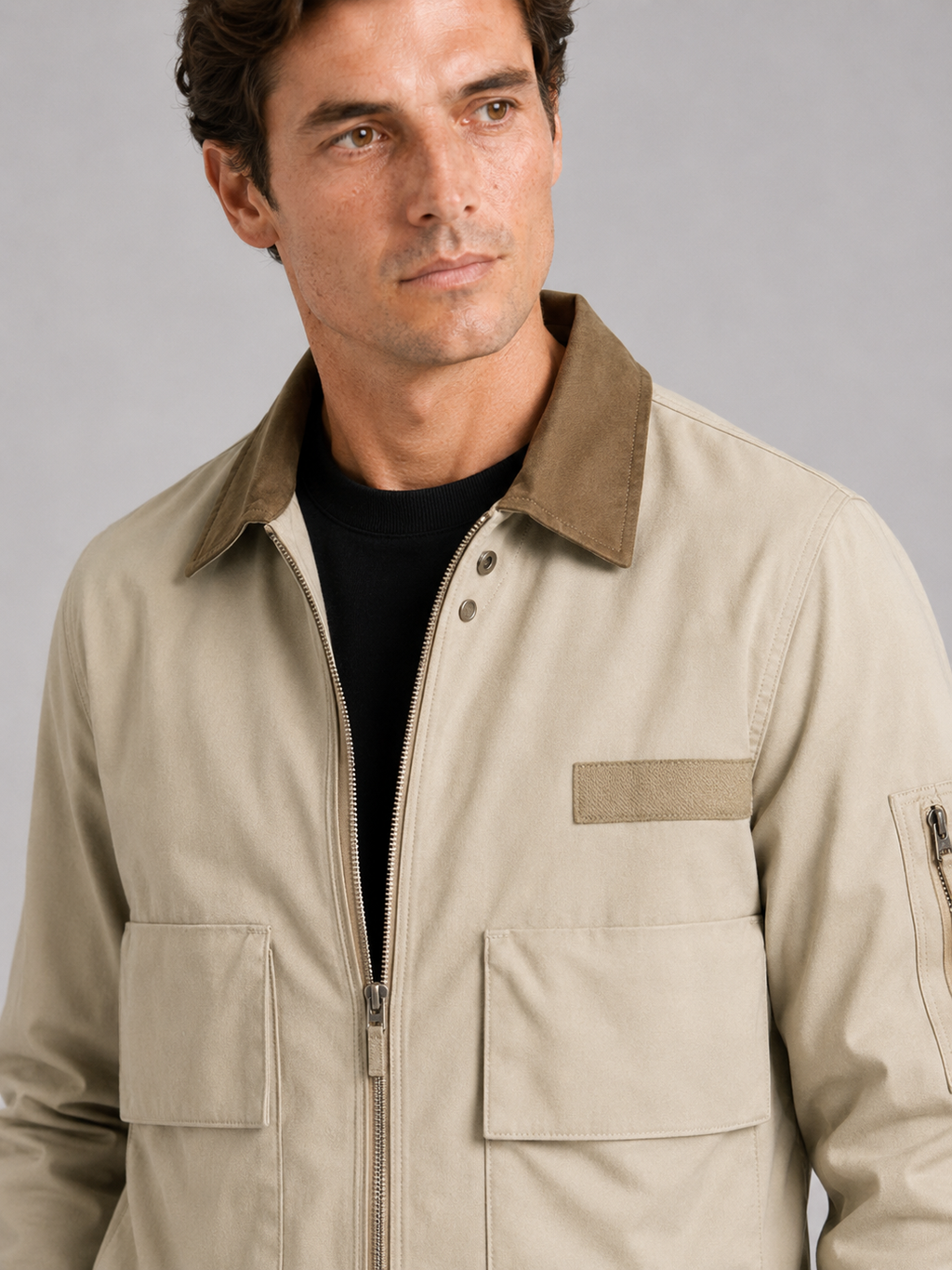 Close up of khaki pilot jacket showing durable fabric and zip up front detail