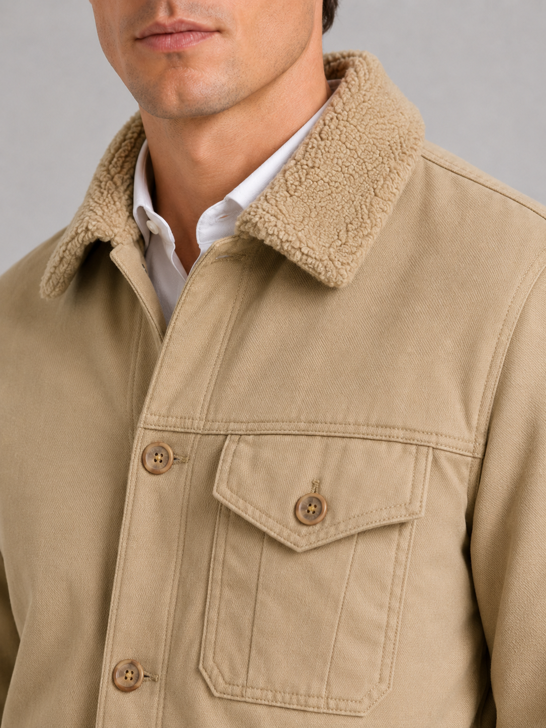 Close up of khaki winter jacket showing soft fur collar and insulated fleece lined construction