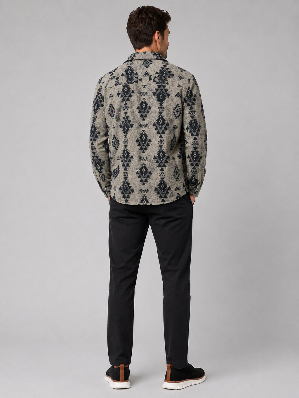 Back view of a man wearing a khaki heavyweight flannel jacket showing the relaxed fit, long sleeves, warm brushed fabric, and classic shacket silhouette
