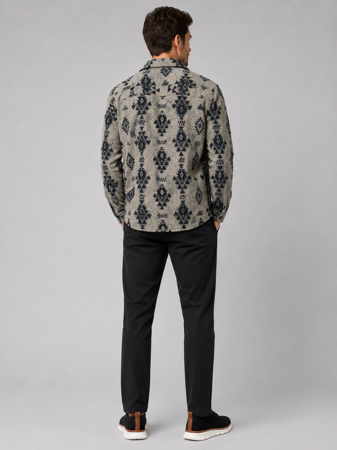 Back view of a man wearing a khaki heavyweight flannel jacket showing the relaxed fit, long sleeves, warm brushed fabric, and classic shacket silhouette