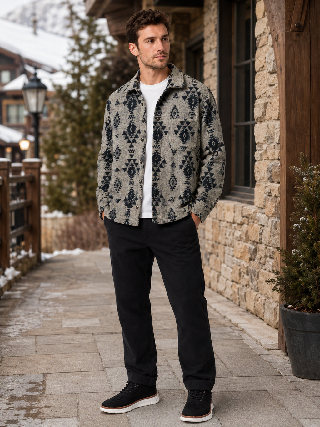 Man wearing a khaki heavyweight flannel shacket in a casual outdoor fall winter outfit with jeans