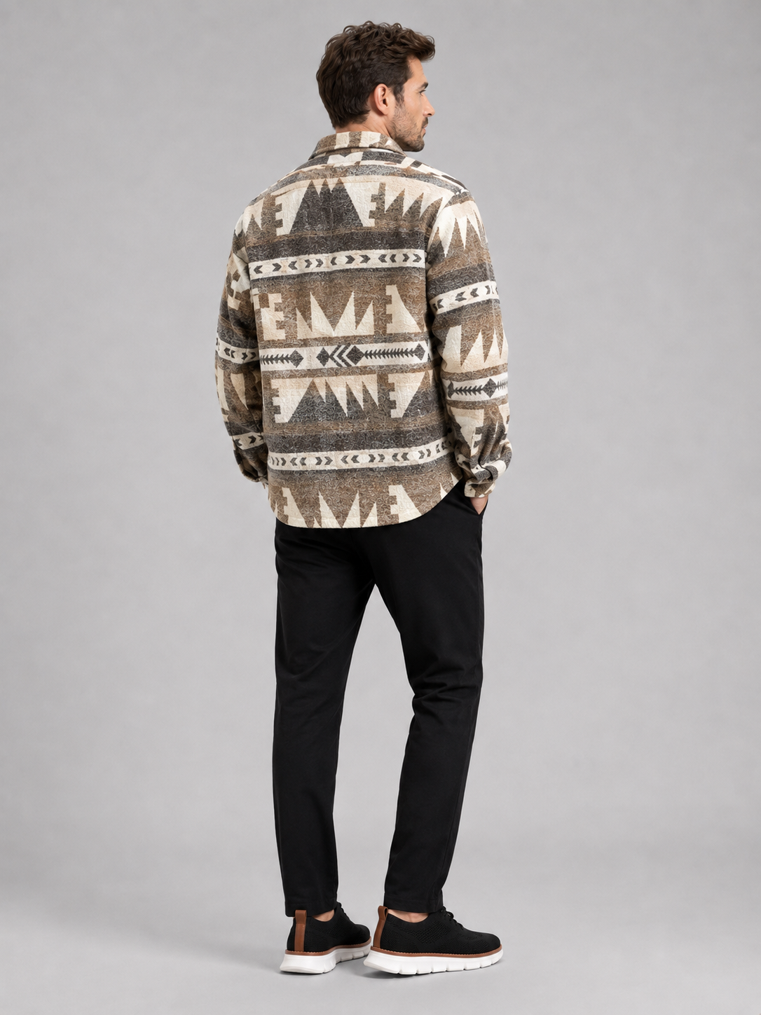 Back view of a man wearing a khaki flannel shirt jacket showing the ethnic print, relaxed fit, long sleeves, and heavyweight wool blend fabric
