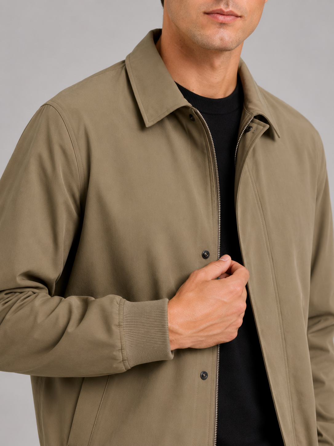 Close up of khaki fall jacket showing smooth lightweight fabric and refined lapel collar detail