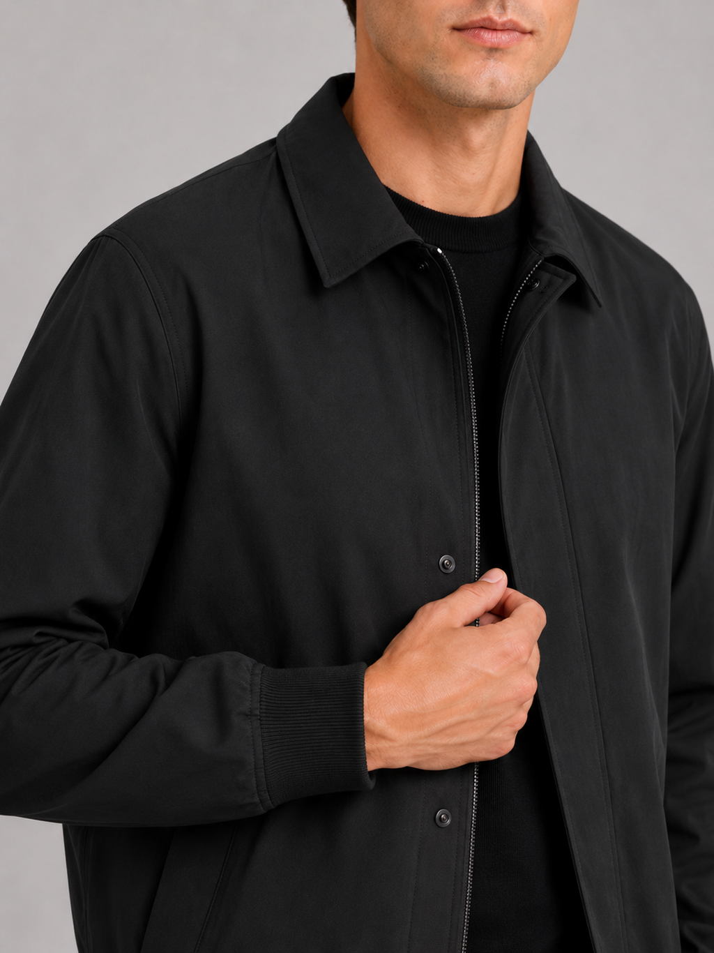 Close up of black fall jacket showing smooth lightweight fabric and refined lapel collar detail