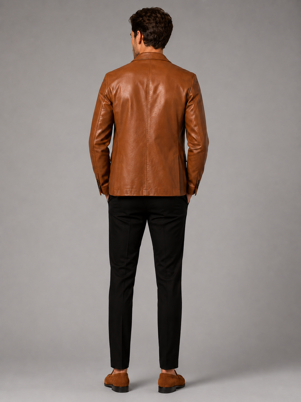 Back view of a man wearing a khaki leather blazer jacket showing the tailored slim fit, smooth leather finish, and structured silhouette