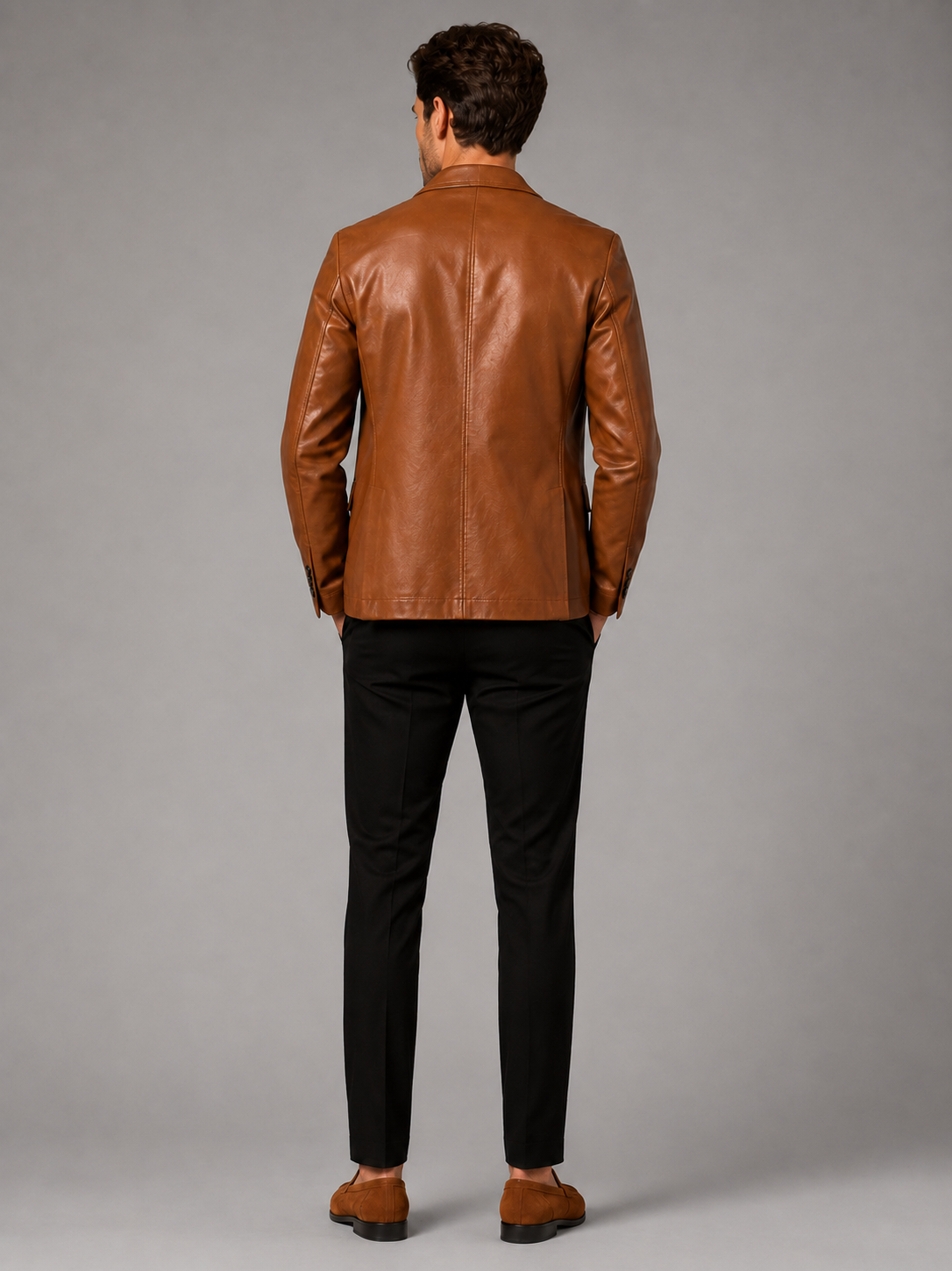 Back view of a man wearing a khaki leather blazer jacket showing the tailored slim fit, smooth leather finish, and structured silhouette