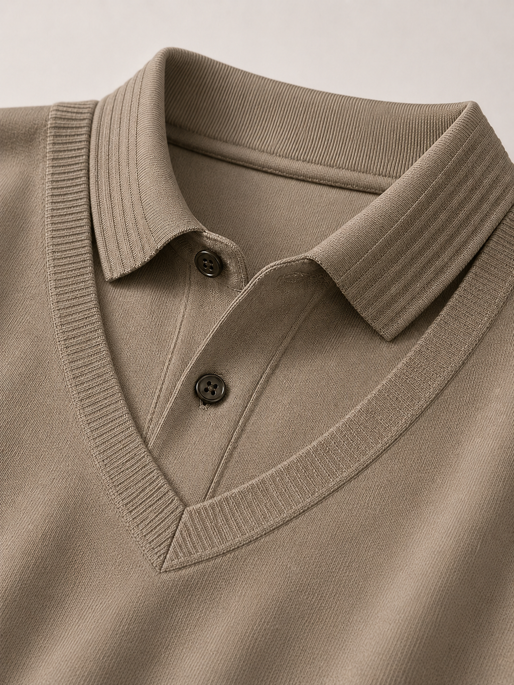Close up of khaki polo shirt showing soft lightweight fabric and refined collar detail