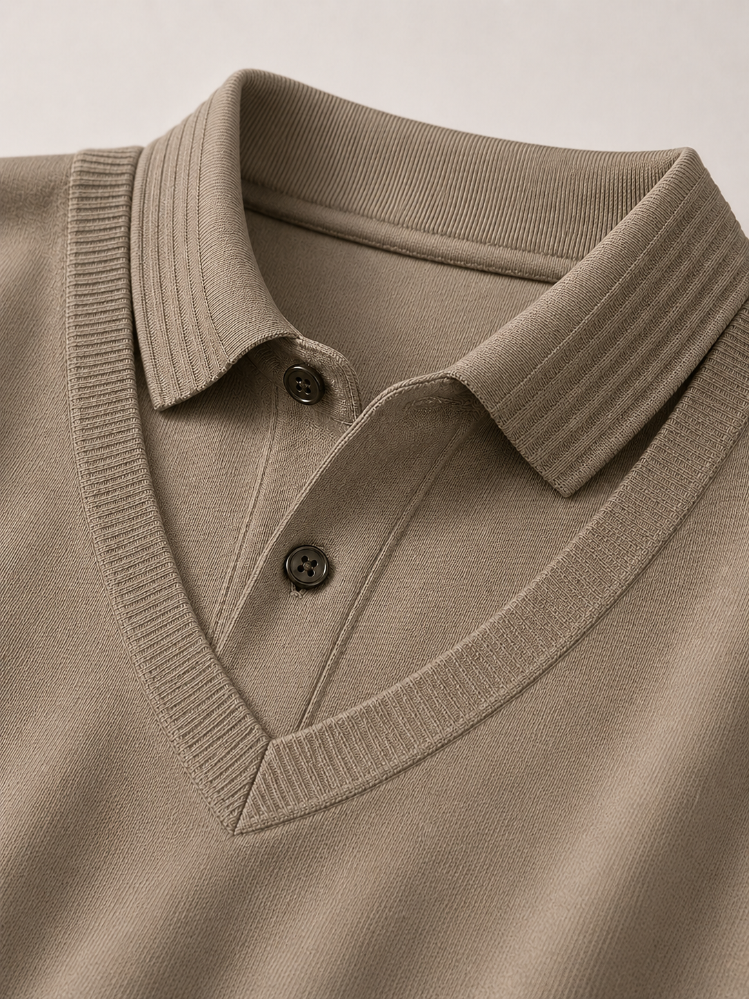 Close up of khaki polo shirt showing soft lightweight fabric and refined collar detail
