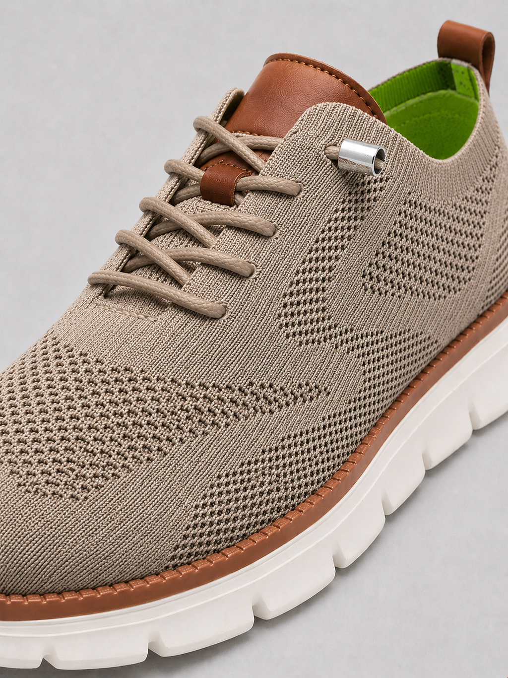 Close up of khaki mesh sneakers showing breathable knit upper and cushioned sole detail
