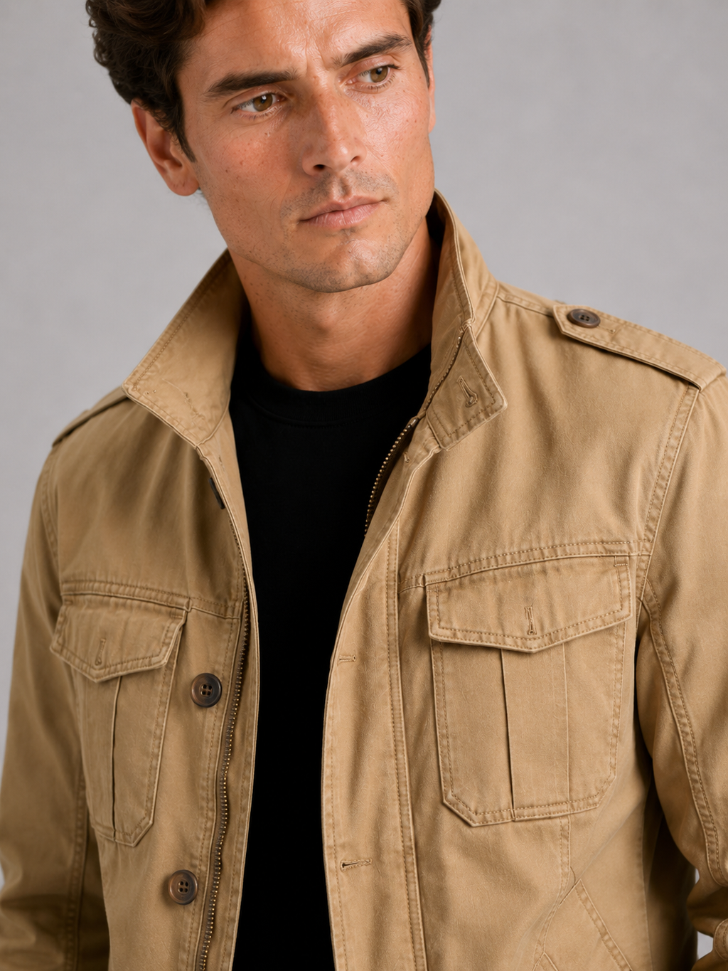 Close up of khaki military cargo jacket showing durable heavyweight cotton fabric and utility pocket detail
