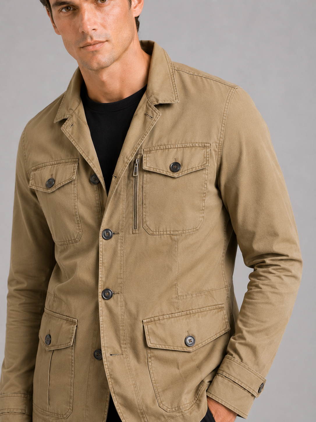 Close up of khaki military jacket showing durable cotton fabric and functional multi pocket detail