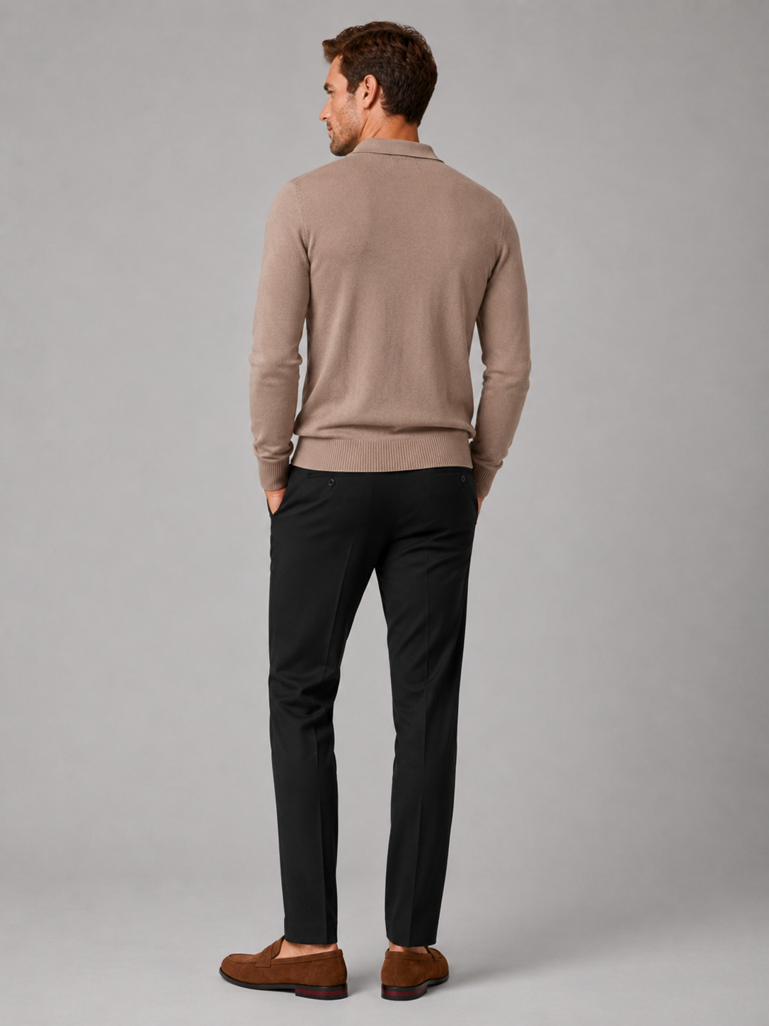 Back view of a man wearing a khaki quarter zip polo shirt showing the slim fit, long sleeves, and textured fabric construction