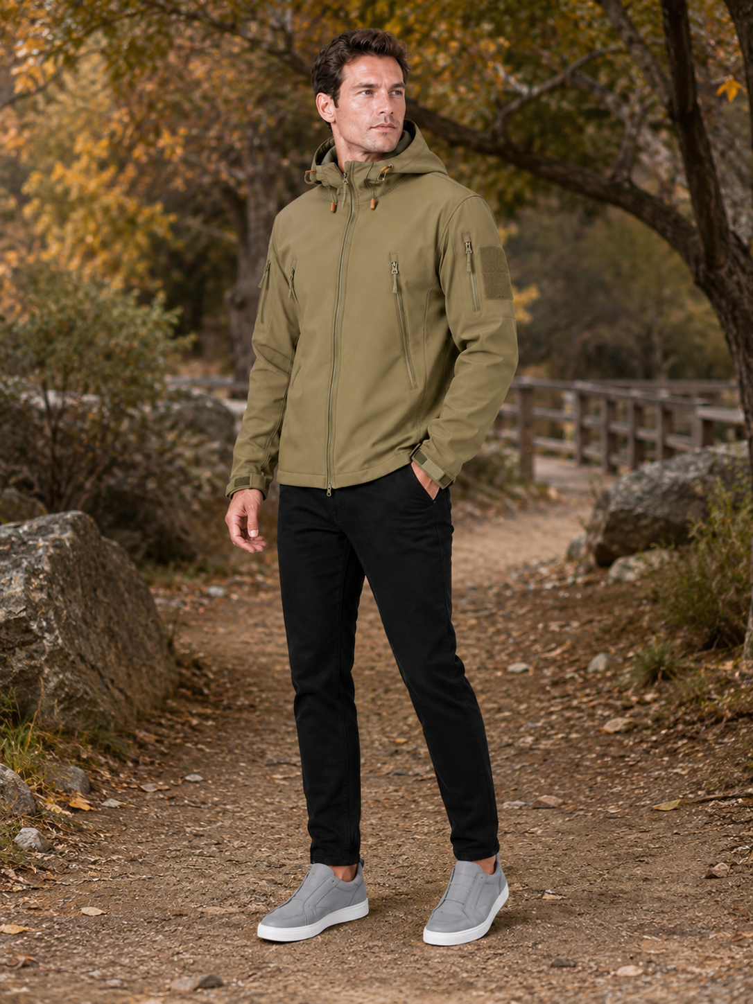 Man styling khaki tactical hooded jacket in a rugged outdoor work and hiking lifestyle outfit
