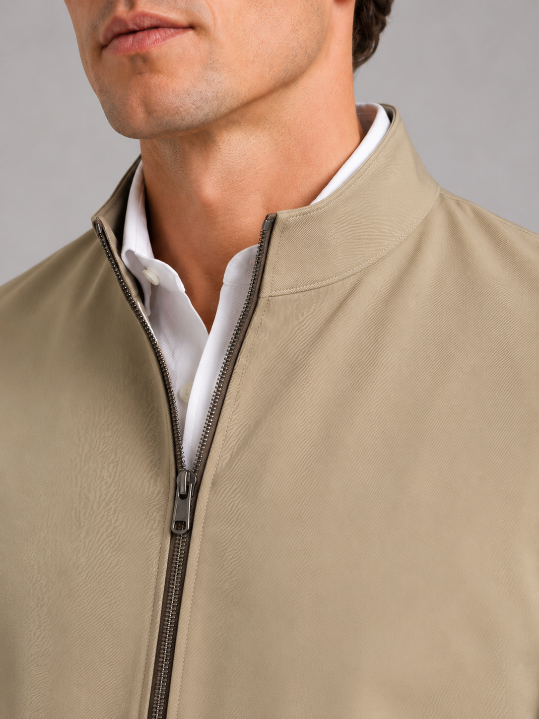 Close up of khaki workwear jacket showing durable wear resistant fabric and stand collar detail