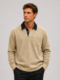 Front view of a man wearing a khaki corduroy long sleeve polo shirt with a contrast turn-down collar and relaxed fit