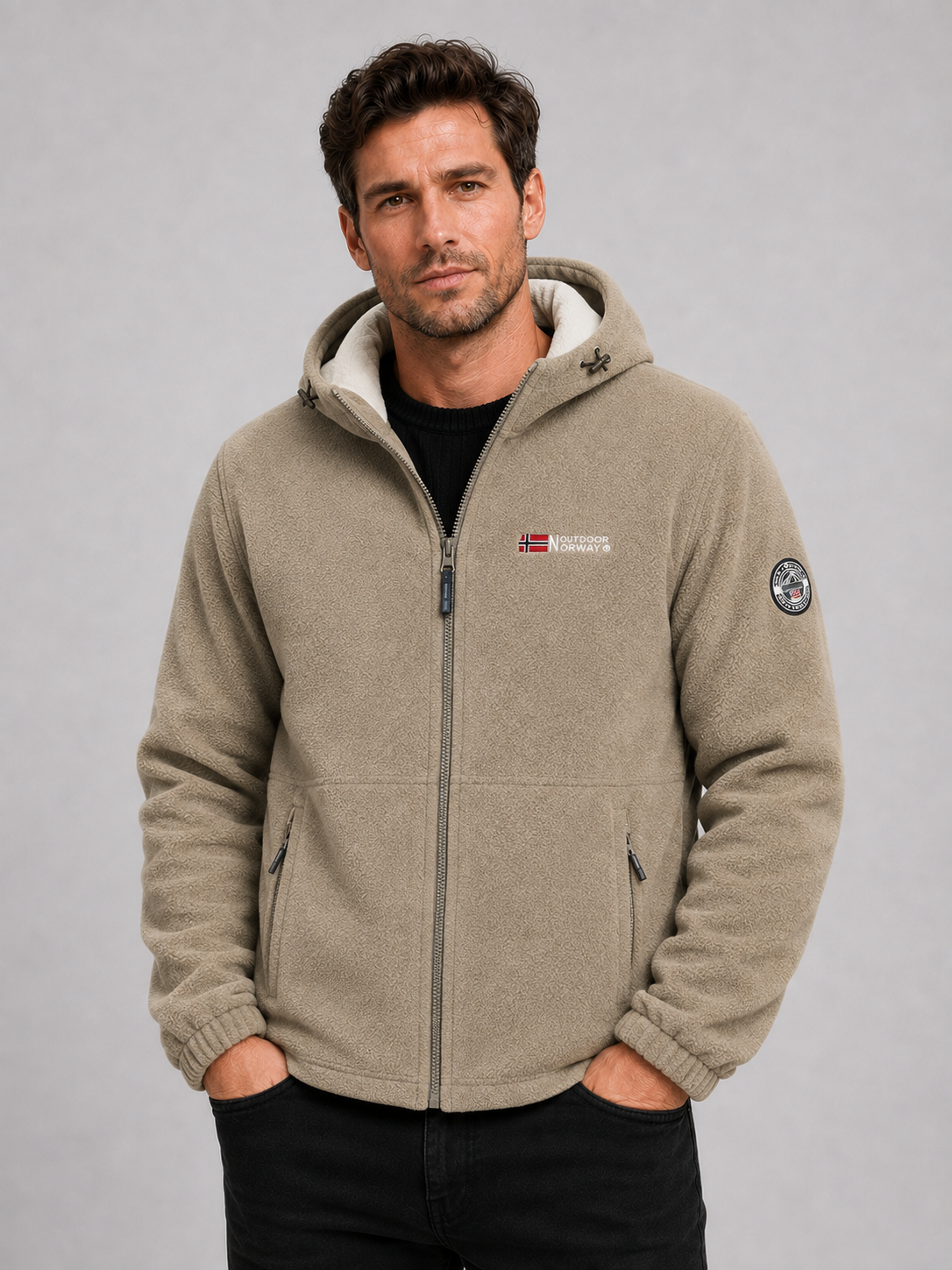 Front view of a man wearing a khaki hooded fleece jacket with a windproof design, thick warm construction, and full zip front
