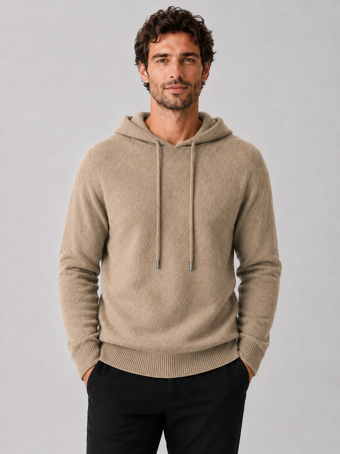Front view of a man wearing a khaki wool hoodie sweater with a soft knit design, attached hood, and long sleeves
