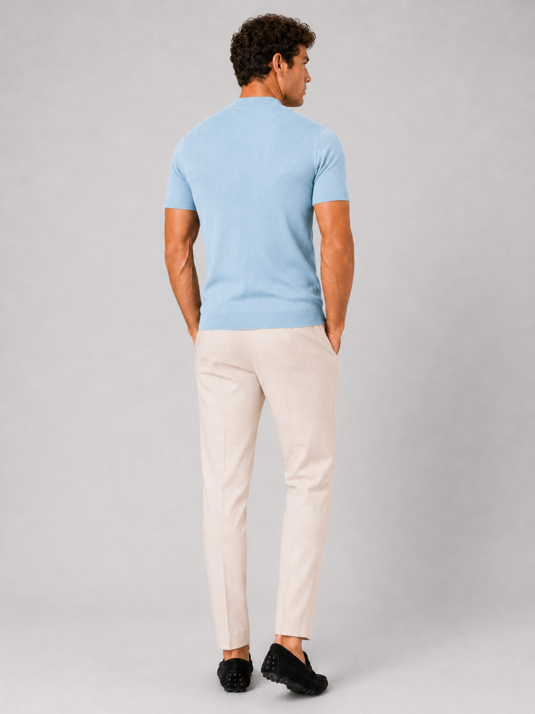 Man styling light blue mock neck ribbed t shirt in a clean summer lifestyle outfit