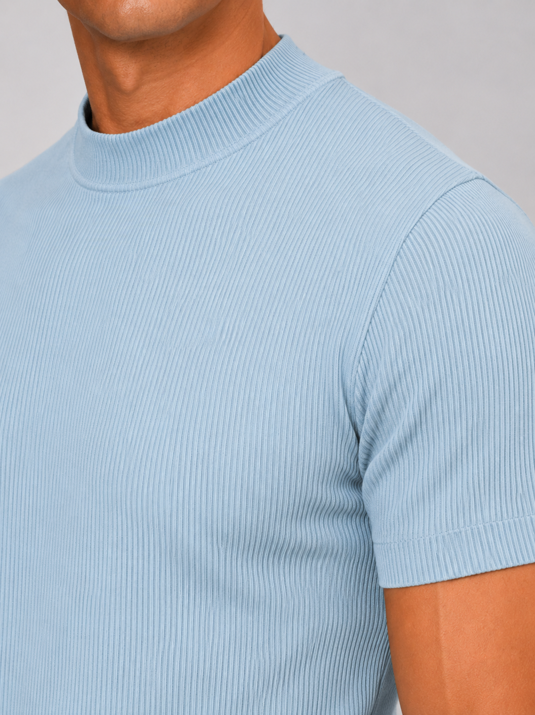 Close up of light blue ribbed t shirt showing soft stretch fabric and mock neck detail